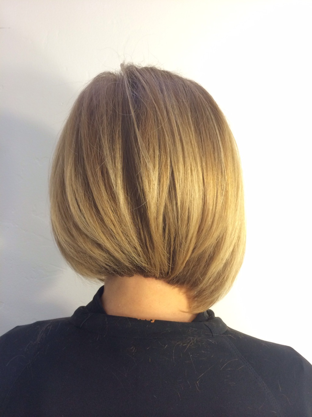 A classic bob with a twist. Channel slicing blurs any  layer lines and subtle undercutting allows the hair to fall effortlessly hugging the occipital bone. Slight  asymmetry keeps the usual unusual and interesting. Stand outside the box with a modern take on the OG BOB- Perfectly Framed. Uniquely, you.